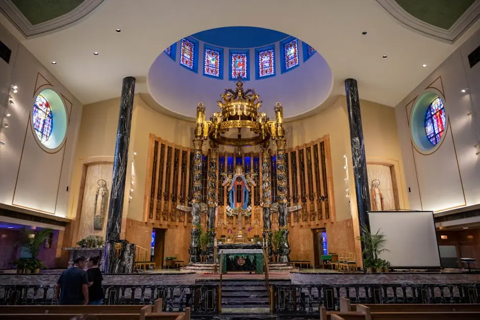 Ornate church altar with golden decorations and stained glass windows.